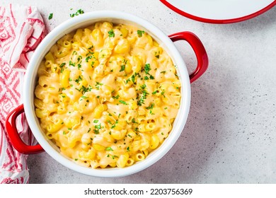 Mac and cheese in red pot, top view. Traditional American food.