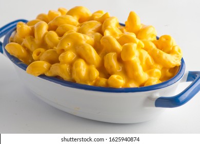 Mac N cheese. Macaroni pasta mixed with melted cheddar cheese, grilled Cajun shrimp, crispy bacon, jalapeños, spicy corn salsa, and cilantro. Classic American bar appetizer, loaded Mac n cheese. - Powered by Shutterstock