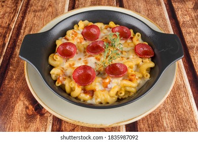 Mac N Cheese With Sausage On The Plate On The Table