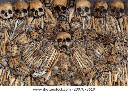 Macabre sculptural design of a wall of bones and human skulls from The Chapel of Bones located in the city of Évora in Portugal. It was built the 17th  at the initiative of three Franciscan monks.