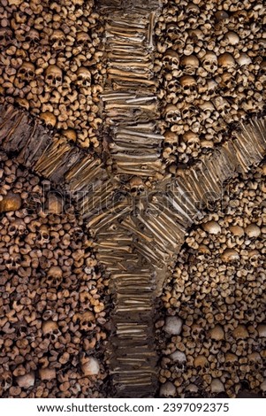 Macabre sculptural design of a wall of bones and human skulls creating a fountain or Y bones shaped design from The Chapel of Bones. Evora, Portugal.
