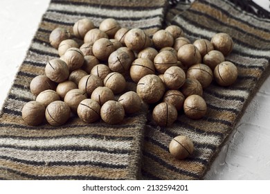 Macadamia Nuts On A Canvas With A Traditional African Ornament. High Quality Photo