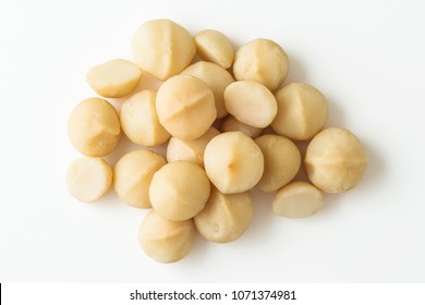 Macadamia nuts on white background top view