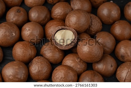 Macadamia nuts pattern. Natural raw peeled macadamia seeds and shells background, the hardest and most expensive nuts in the world bg top view