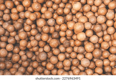 macadamia nuts texture background, fresh natural shelled raw macadamia nuts in a full frame, close up pile of roasted macadamia nut - top view