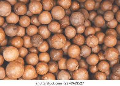 macadamia nuts texture background, fresh natural shelled raw macadamia nuts in a full frame, close up pile of roasted macadamia nut - top view