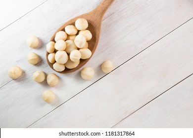 macadamia nuts in wooden spoon
