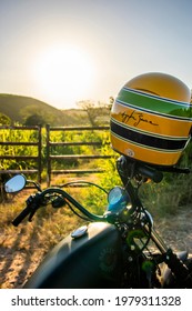 Macae-Rio De Janeiro-Brazil - 01-30-2021: Harley Davidson Motorcycle Iron 883 With Ayrton Senna Helmet At The Sunset. 