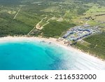 Macao beach with sandy coastline, turquoise water and stone cliff. Famous shore for surfing in Dominican Republic. Aerial drone view 