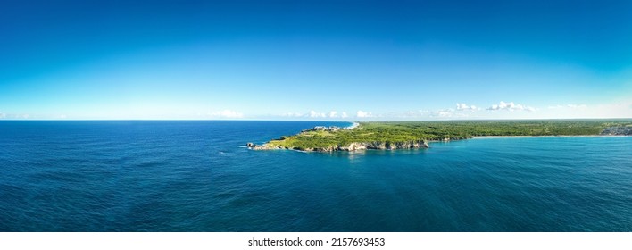 Macao beach with sandy coastline, turquoise water and stone cliff. Famous seashore for surfing in Dominican Republic. Aerial panorama view 