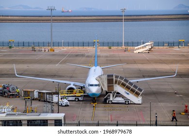Macao, China - April 2, 2020: Airplane goes to the position for takeoff at an airport runway at macao airport.