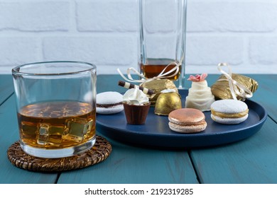 Macaron Next To Small Chocolate Glass With Whipped Cream, Walnut Cameo, Truffle And Whiskey Glass_side View.