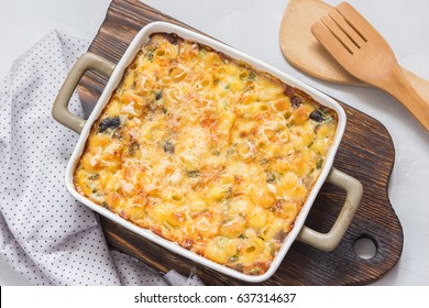 Macaroni And Cheese In A Backing Dish On Wooden Board. Top View.