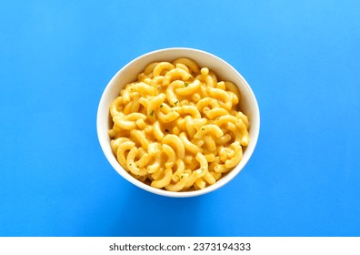 Macaroni and cheese in bowl over blue background. Close up view - Powered by Shutterstock