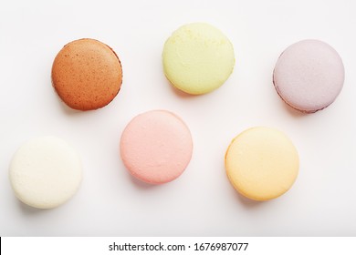 Macaroni cookies of different colors on a white background, isolate.