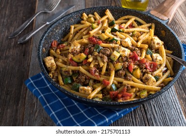 Macaroni Dish With Ground Beef, Vegetables And Feta Cheese In A Skillet Isolated On Wooden Table. 