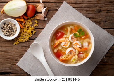 Macaroni Soup With Shrimps ,tomato ,carrots And Onion On White Bowl.Top View