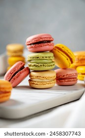 Macarons cookies, stack of french macarons on bright background. Sweet dessert, sugar