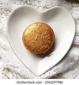 Macarons Gold And Tasty On White Plate Heart