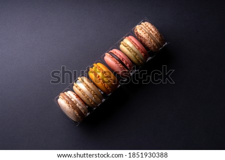 Macarons or macaroons on black background in a box