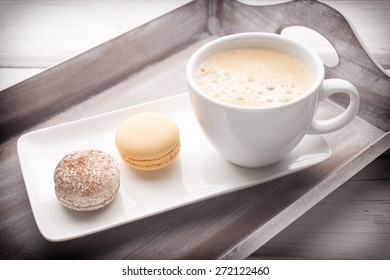Macaroons and coffee on the table. Studio shoot.