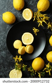 Macaroons, Lemons And Flowers On Black Smokey Background