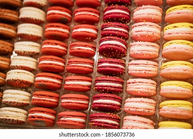 Macaroons In A Row In Different Colors On The Counter In The Store