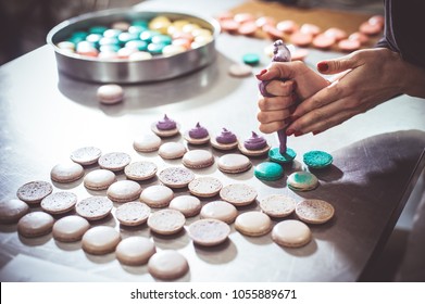 Macaroons Shells In A Tray Fresh From Oven. Process Of Making Macaron Macaroon , French Dessert, Squeezing The Dough Form Cooking Bag. Food Industry, Mass Or Volume Production.