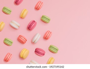 Macaroons Top view photo in minimal style Many colorful french biscuits on light pink background