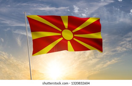 Macedonia flag waving in the wind against a blue sky and clouds