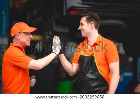 machanic team smiling to each other as they are a great teamwork, good teamwork good life, professional machanic engineer, work concept.wearing uniform