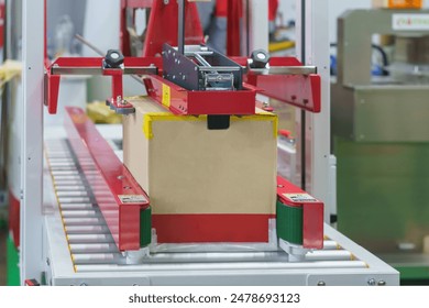 machine appears to use tape to close and seal cardboard boxes automatically - Powered by Shutterstock