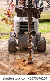 A Machine With Auger Attached For Digging Post Holes In The Soil