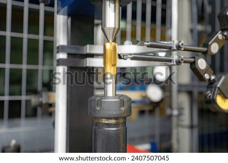 A machine for checking cutters and cutting tools for runout in the centers using indicators.