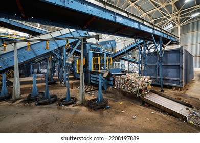 Machine for compacting household waste. Compaction of garbage into briquettes and bales. - Shutterstock ID 2208197889