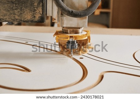 Machine with computer numerical control for cutting wood with various router bits.