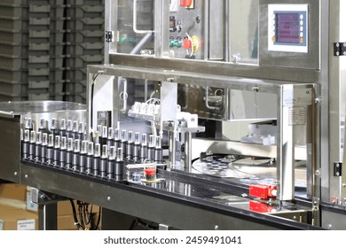 A machine in a cosmetics factory for putting lipstick in tubes. - Powered by Shutterstock