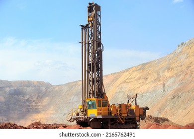 Machine for drilling wells in the quarry. Drilling of boreholes for laying an explosion in a quarry. Technologies of open pit mining of minerals. - Shutterstock ID 2165762491