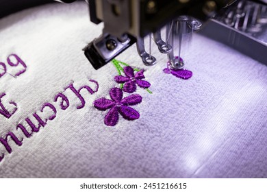 Machine embroidery of a bouquet of flowers on a purple cloth. Embroidery of a bouquet of purple flowers and an inscription. A gift for loved ones. Bulgarian holiday March 8. Women's Day. - Powered by Shutterstock