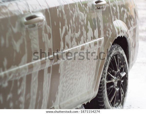 machine in the foam from car shampoo. self-service\
car wash. dripping\
foam.