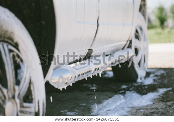 Machine in the foam.
Car wash. Car in the foam from the cleaning agent. Parts of the
machine in the relics