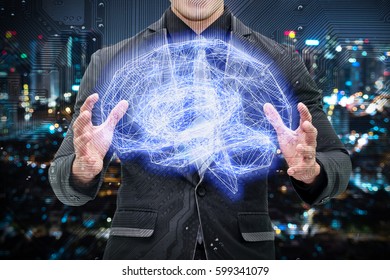 Machine learning , artificial intelligence , ai , deep learning and future concept. Man suit holding Wireframe Brain connect with circuit electronic graphic with bokeh city background