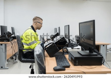 Machine learning. Electrical engineer. Works on desktop computer. Male engineer training Programmable logic controller in workshop. Industrial computer concept