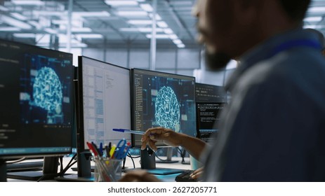 Machine learning expert in data center maintaining company network infrastructure. Worker using artificial intelligence server hub to ensure optimal system performance, camera A