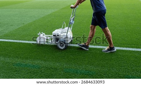 Machine for marking lines on the playing field, pushed by a man