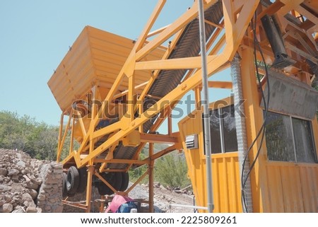 Machine for mixing cement, sand and water for use in making buildings. giant construction machine.