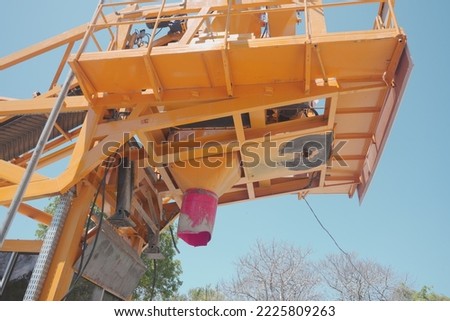 Machine for mixing cement, sand and water for use in making buildings. giant construction machine.