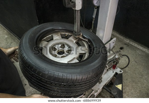 Machine mounts the tyre on a rim. Installing\
wheel process