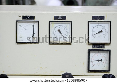 Machine operating console in factory. Old control panel on production line. Many buttons, switches, dials and instruments. Industry. Dashboard control, close up. Old technology.