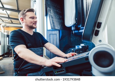 Machine operator programming modern industrial cnc lathe - Shutterstock ID 1931793848
